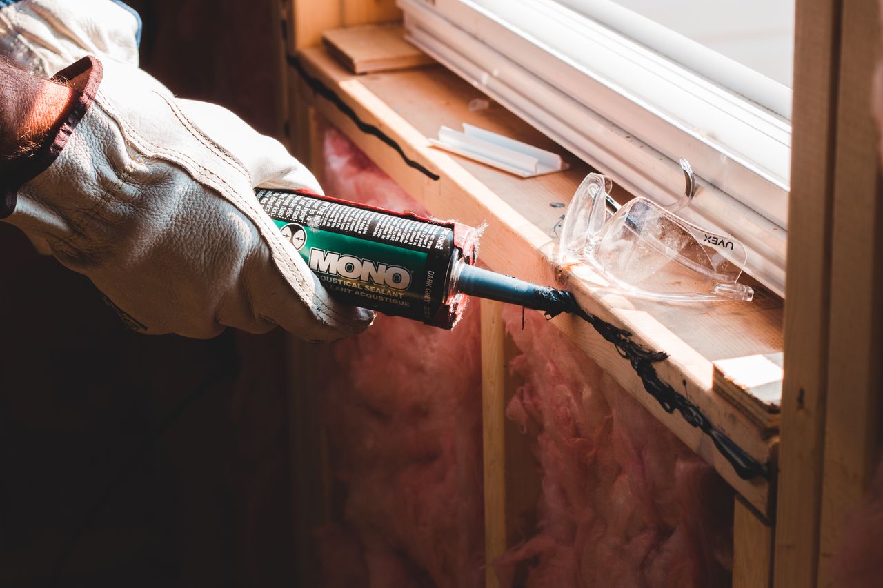 Crafting Captivating Headlines: Your awesome post title goes here Crop unrecognizable workman in glove applying caulk from bottle on seam during window montage work in building